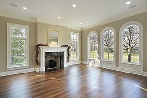 A home with rectangular windows flanking the fireplace and domed picture windows on the adjoining wall